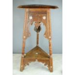 An Indian hardwood carved table, inlaid with mother of pearl.