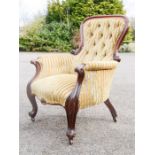 A Victorian mahogany nursing chair, with striped upholstery. [Provenance: Gumley Hall,