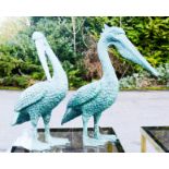 A pair of green patinated bronze pelicans.