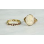 A yellow metal cameo ring and a yellow metal band set with garnets, 5.5g