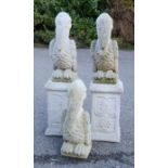 A group of reconstituted stone garden ornaments in the form of pelicans.