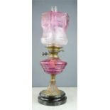 A Victorian cranberry glass parafin lamp.