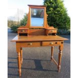 An early 20th century dressing table with mirrored back.