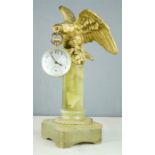 A bronze and onyx clock in the form of an eagle, holding spherical clock case in its beak. 32cm by