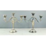 A pair of silver plated table candleabra.