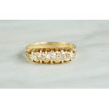 An 18ct gold and diamond ring, Edwardian setting, with five graduated diamonds, size P, 3.8g.