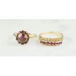 Two 9ct gold and garnet set rings, one set in a flowerhead design, the other in a band.