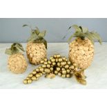 A group of decorative graduated paper pineapples and grapes.