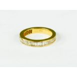 An 18ct gold and diamond ring, the band set with baguette cut diamonds, 5.1g.