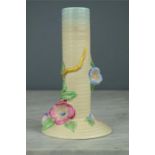 A Clarice Cliff stem vase modelled with flowers no 927 to the base, 19cm high.