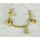 A silver gilt charm bracelet with silver gilt charms, 32.8g total weight.