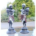 A pair of cold painted bronze blackamoors, 24cm high.