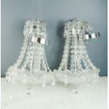 A pair of modern cut glass and chrome chandeliers.