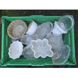 A large group of glass and stoneware jelly moulds.