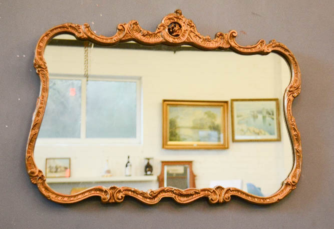A giltwood Rococo style wall mirror / overmantle.