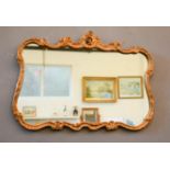 A giltwood Rococo style wall mirror / overmantle.