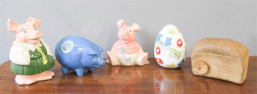 A group of five money boxes, including two Wade Natwest pigs, Madrigal Stoneware Bread, etc.