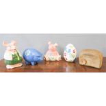 A group of five money boxes, including two Wade Natwest pigs, Madrigal Stoneware Bread, etc.