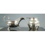 A silver milk jug London 1911, Edward Barnard & Son Ltd, together with a silver sauce boat, 1896,