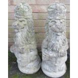 A reconstituted stone garden ornament in the form of two lions with crowns.