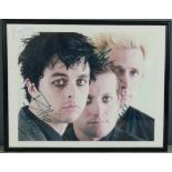 An original certificated autograph photo of the band Green Day.