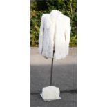 A white rabbit fur jacket and muff.