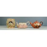 A hexagonal teapot with lacework decoration, and a Watcombe hand painted tea pot and another.