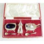 A silver cruet set, with original presentation box.