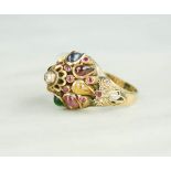 An 18ct gold and semi precious stone set ring, with central diamond and pink rubies, 5.3g.
