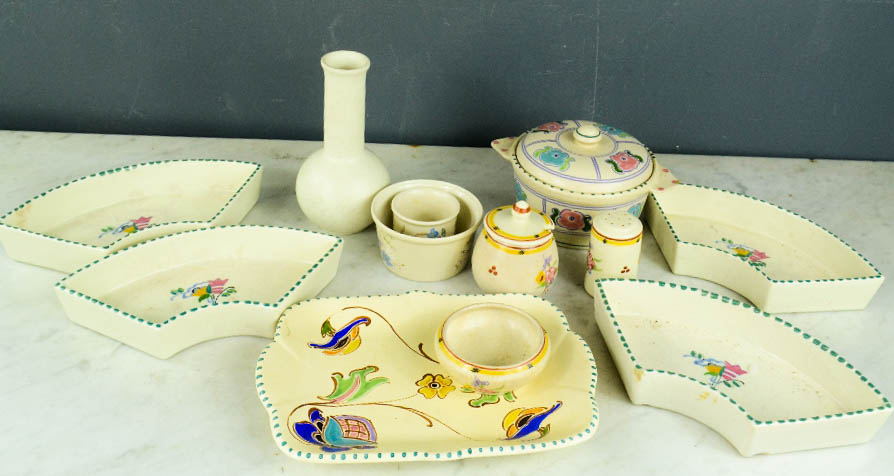 A group of Poole pottery, including four dishes, cruet set, lidded pot etc.