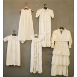A group of four lace christening dresses and a child's dress.