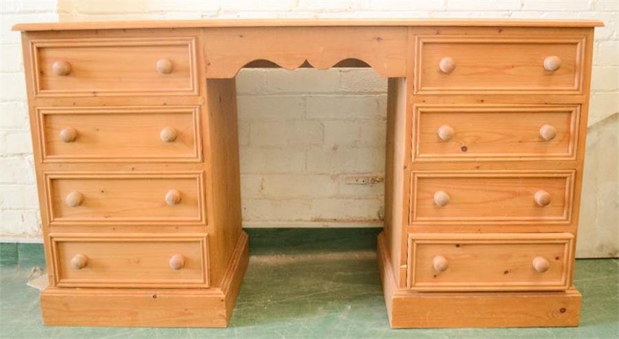 A pine desk, with shaped apron and drawers either side.