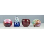 Four glass paperweights: Caithness M73815, M75805, Nova B46472, and an apple.