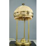 A vintage brass table lamp, with three pillars, and sheep head finials, and shade with gold brocade,