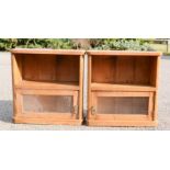 A pair of antique pine wall cabinets, with bevelled glass panels to the doors.