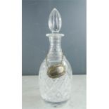 A Victorian cut glass decanter with brandy bottle tag.