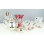 A group of crystal and glassware including a claret jug, cranberry cut glass vase, bowl with