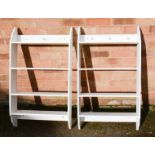 A pair of white bookshelves.