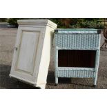A Lloyd loom style bedside cabinet with glass top and pine wall cabinet painted white.