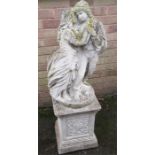 A reconstituted stone garden ornament in the form of two lovers.