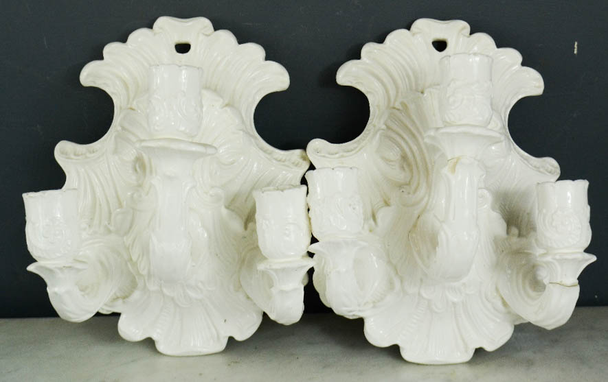 A pair of Rococo style ceramic wall sconces, 23 by 18cm.