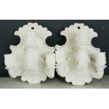 A pair of Rococo style ceramic wall sconces, 23 by 18cm.