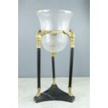 An Empire style candle stand with glass shade, swan supports and black marble base.