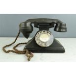 A vintage bakelite telephone in black.