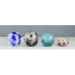 Four glass paperweights including Caithness M8452, Cauldon, Langham.