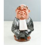 A Chelsea pottery figure of a Judge.