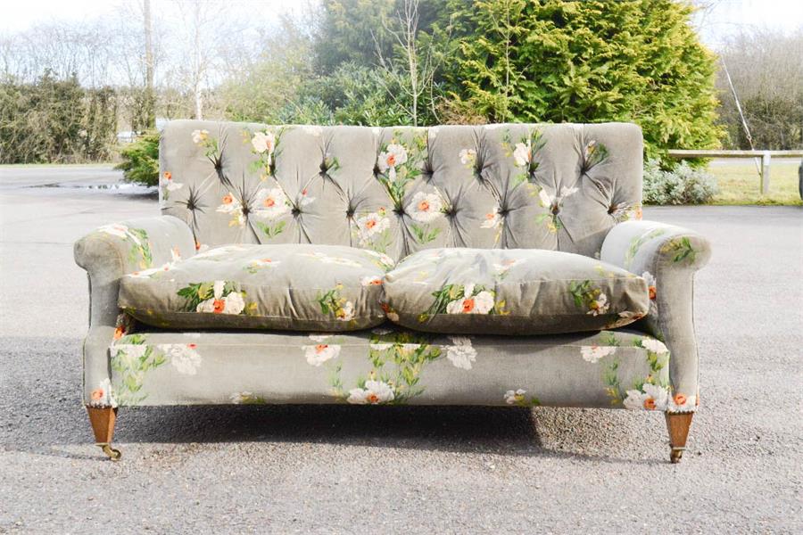 A mahogany framed button back settee, with curved front, upholstered in GP&J Baker Icelandic Poppies