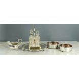 A group of silver plateware to include salver, sauce boat, wine coasters, four piece cut glass cruet