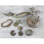 A group of antiquities, including coins and a ring.