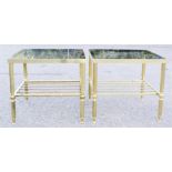 A pair of brass and glass topped tables.